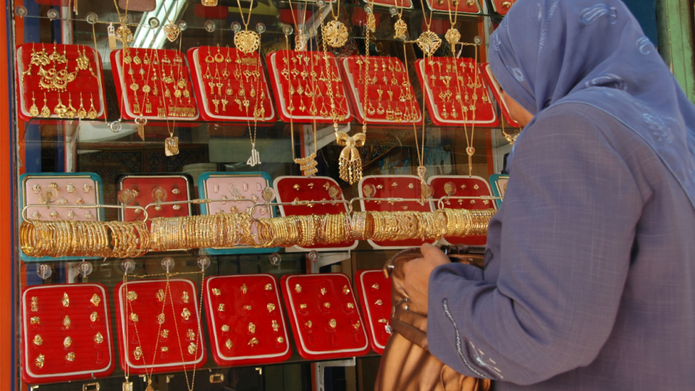 A woman looking in a jewellery shop window in Egypt