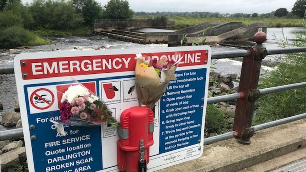 Flowers attached to an emergency sign