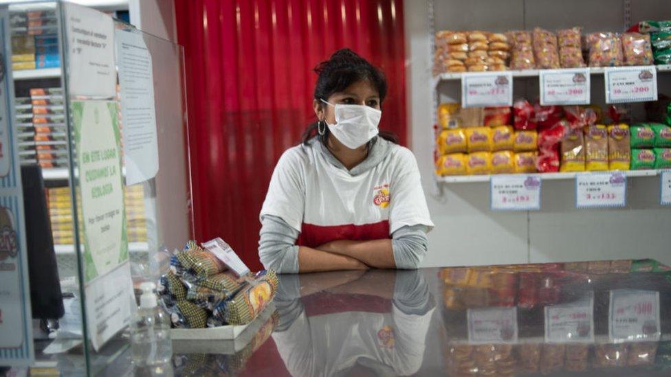 A seller waits for customers at the Central Market in Buenos Aires, Argentina, Saturday, April 3, 2020