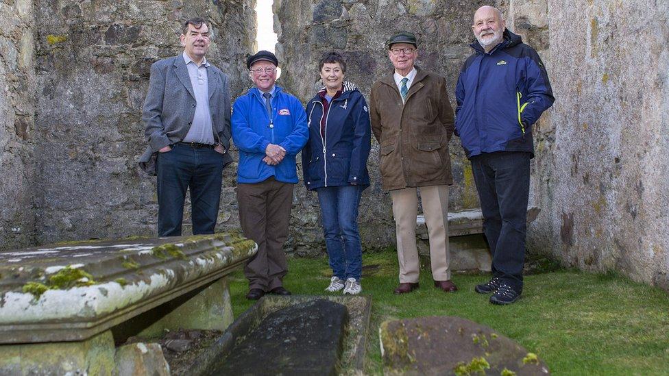 Trust members at the location of the Sword Stone