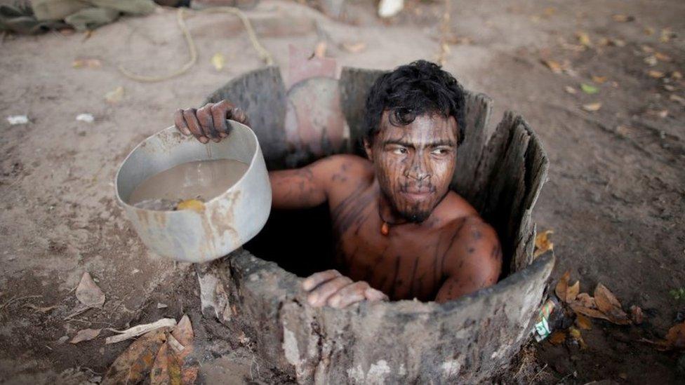 Paulo Paulino Guajajara draws water from a well at a loggers camp on Arariboia indigenous land near the city of Amarante, Maranhao state, Brazil.