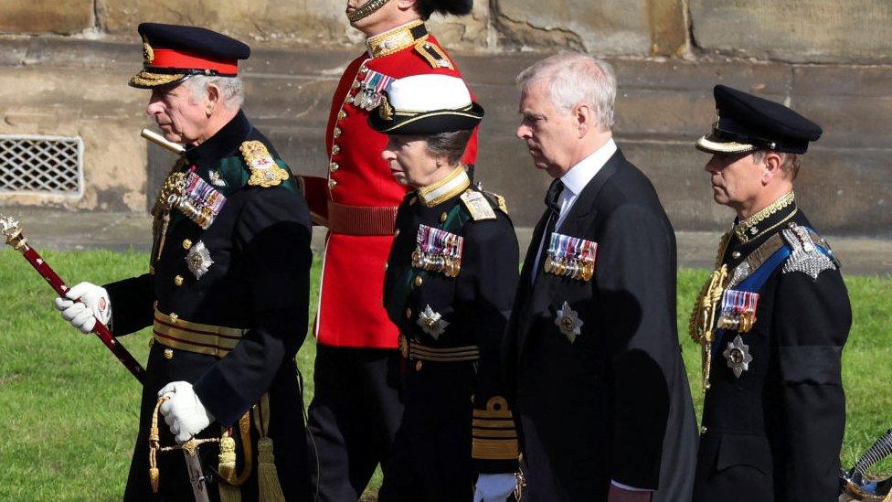 Britain's King Charles III flanked by Britain's Princess Anne, Princess Royal, Britain's Prince Andrew, Duke of York and Britain's Prince Edward, Earl of Wessex, walk behind the procession of Queen Elizabeth II's coffin