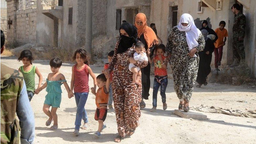 Families leave rebel-held Aleppo through "humanitarian corridors" (Syrian state news agency picture, 02/08/16))