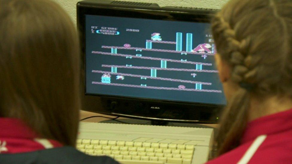 Female students using vintage computer