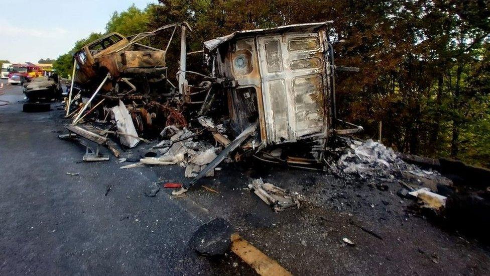 Burnt out debris of car transporter fire on M11