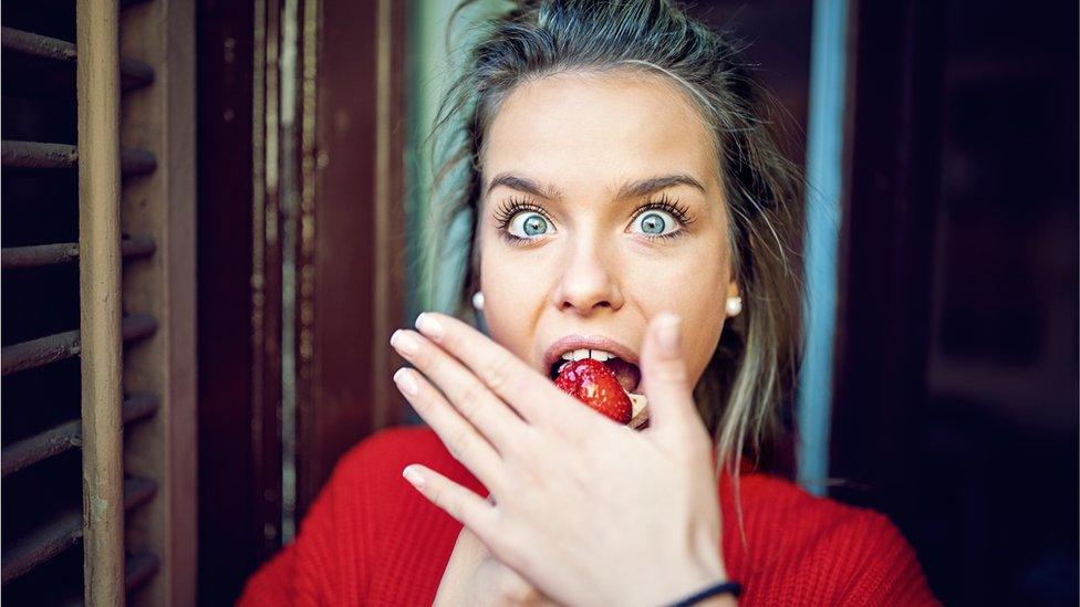 Woman eating a cake