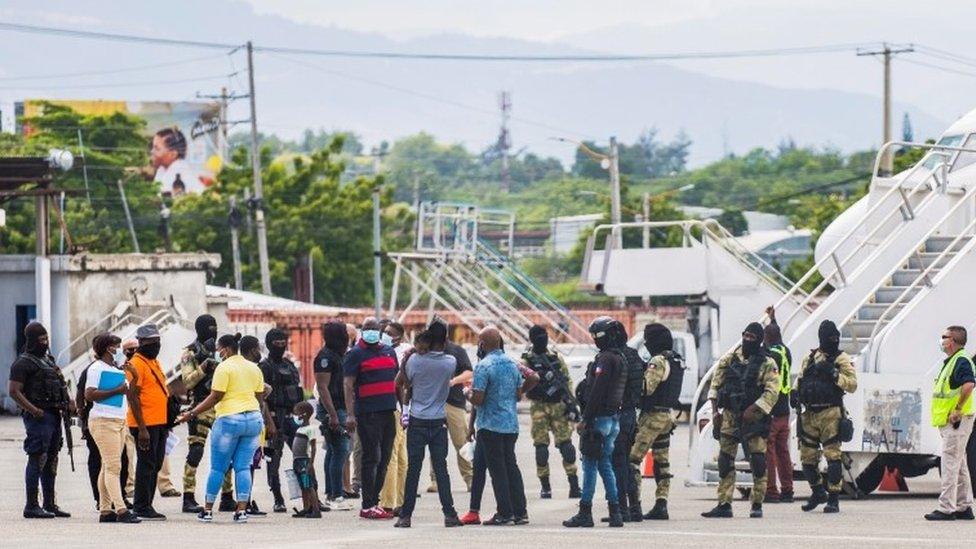 Haitian migrants gather in Port-au-Prince after getting off a plane from Texas