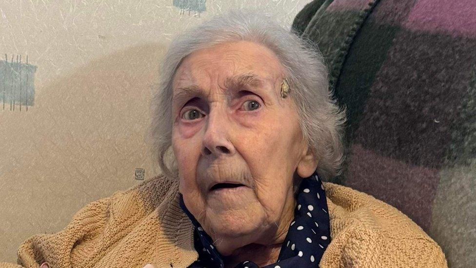 Elderly woman sitting in a care home