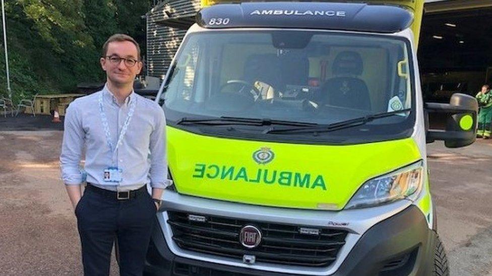 Man in front of ambulance