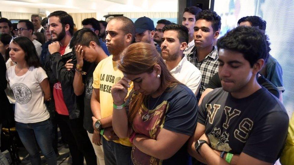 Venezuelan opposition supporters gather at the Democratic Unity Roundtable (MUD) headquarters to wait for the results of the regional elections in Caracas on October 15, 2017