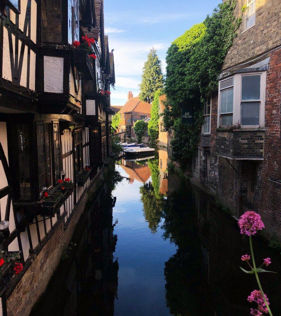 A building reflected in water