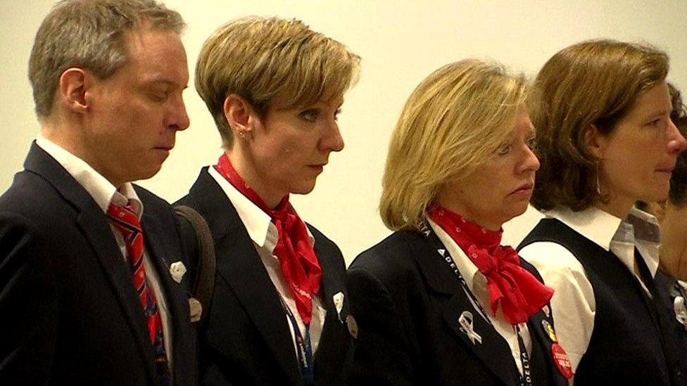 Airport staff standing in silence