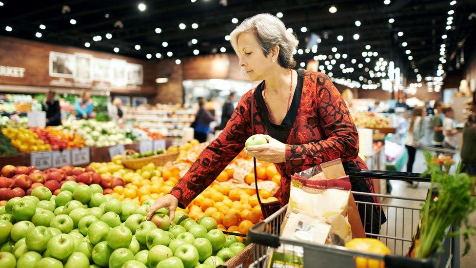 Woman buying fruit in supermarket