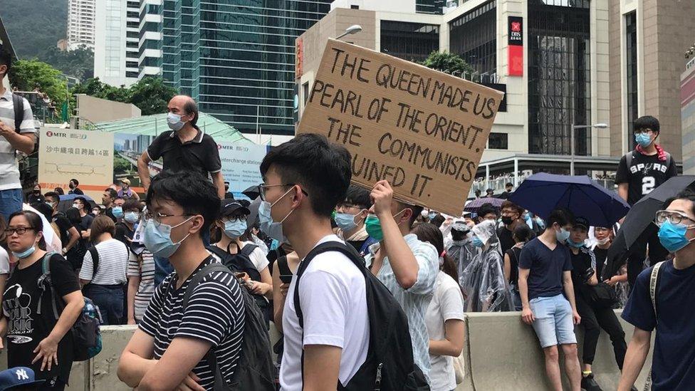 Protesters holding up banners