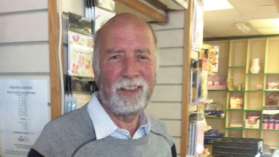 Terry Walters standing in his Post Office