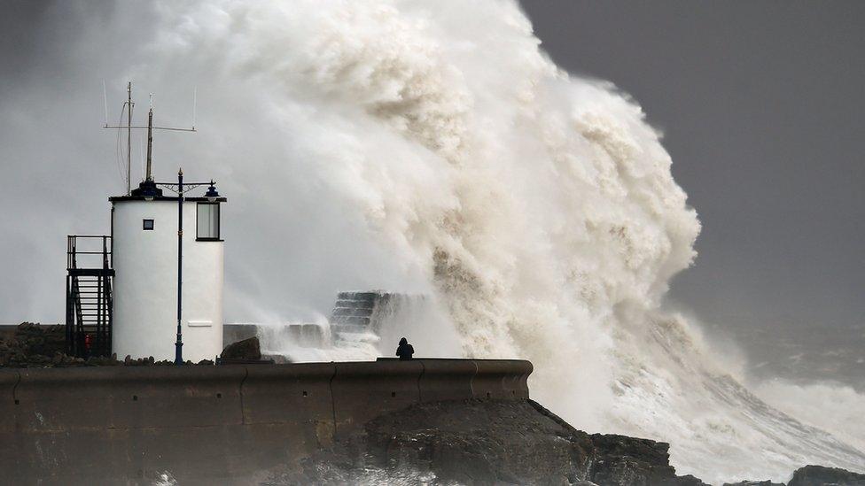 Waves crash over the sea wall at Porthcawl in Wales