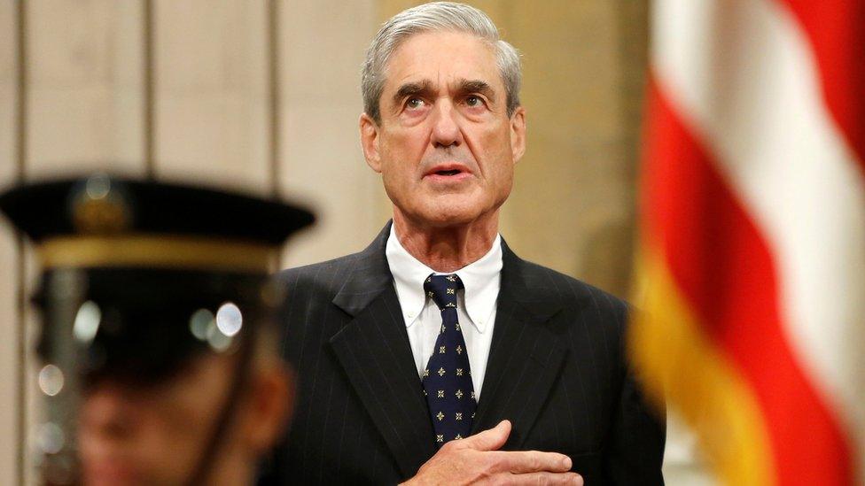 Outgoing FBI Director Robert Mueller stands for the national anthem during a farewell ceremony for him at the Justice Department in Washington, August 1, 2013.