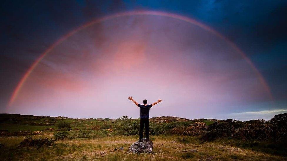 Red rainbow in imposing sky over Anglesey captured by Gareth Mon Jones.