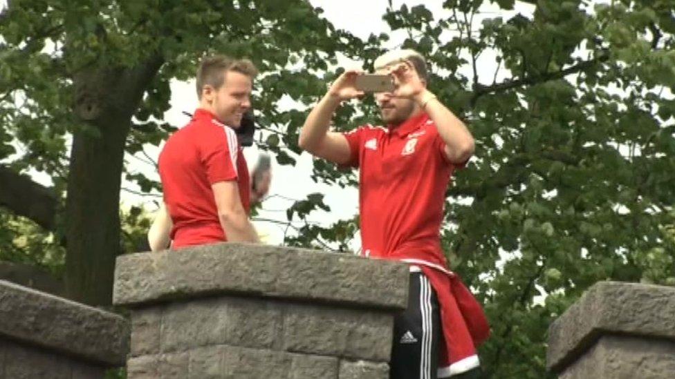 Chris Gunter and Aaron Ramsey take a snap of the crowds from Cardiff Castle