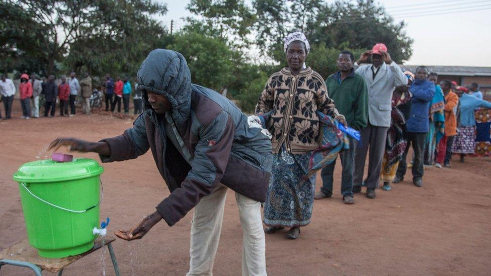 People queuing up to wash their hands