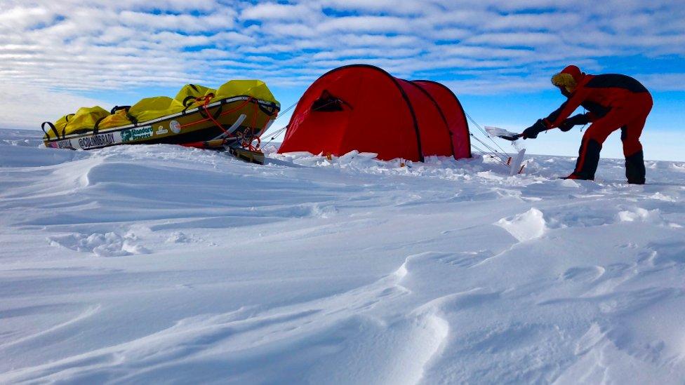 Colin O'Brady's securing his tent at night