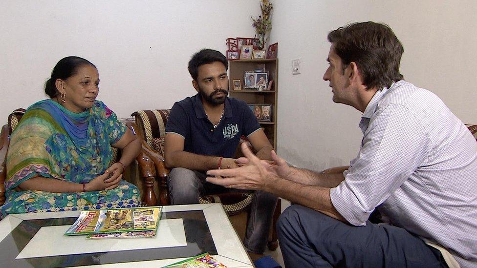 Correspondent Justin Rowlatt speaking with two of Singh's followers.