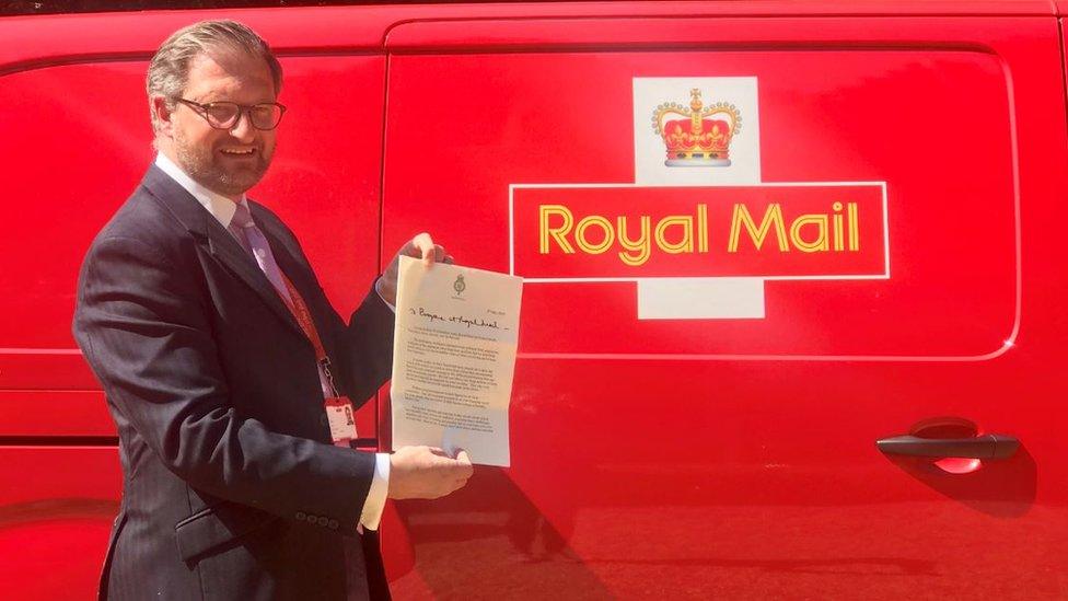 Royal Mail director of public affairs David Gold holds up the letter