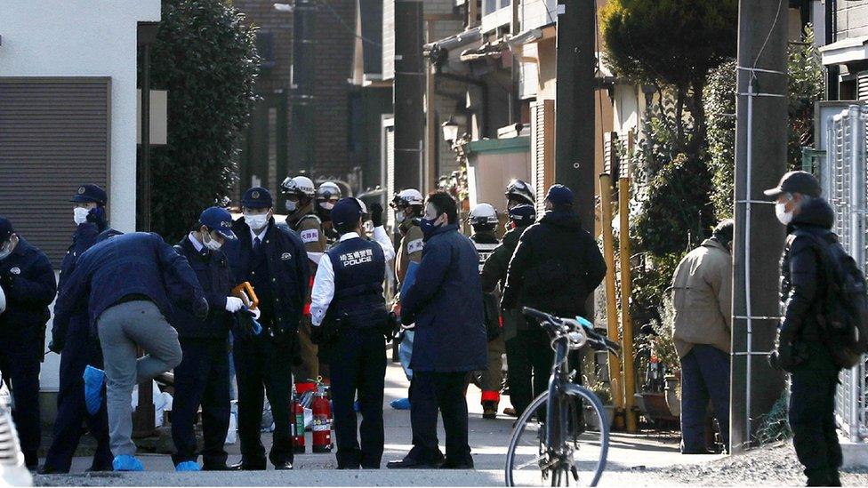 Police and other responders outside the suspect's home on Friday