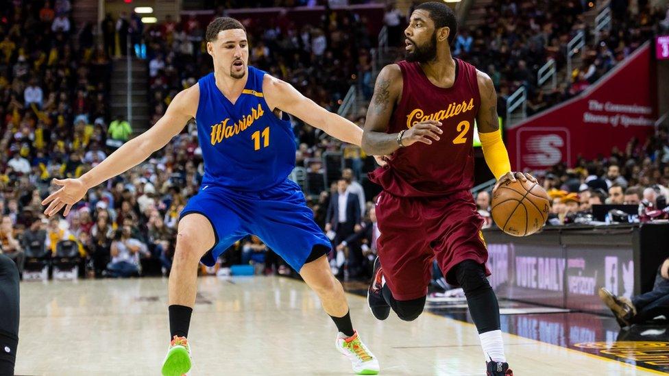 Klay Thompson of the Golden State Warriors puts pressure on Kyrie Irving of the Cleveland Cavaliers during the second half at Quicken Loans Arena on December 25, 2016 in Cleveland, Ohio.