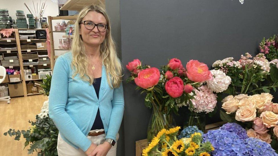 Florist Joanna Konieczwna standing next to her shop displays