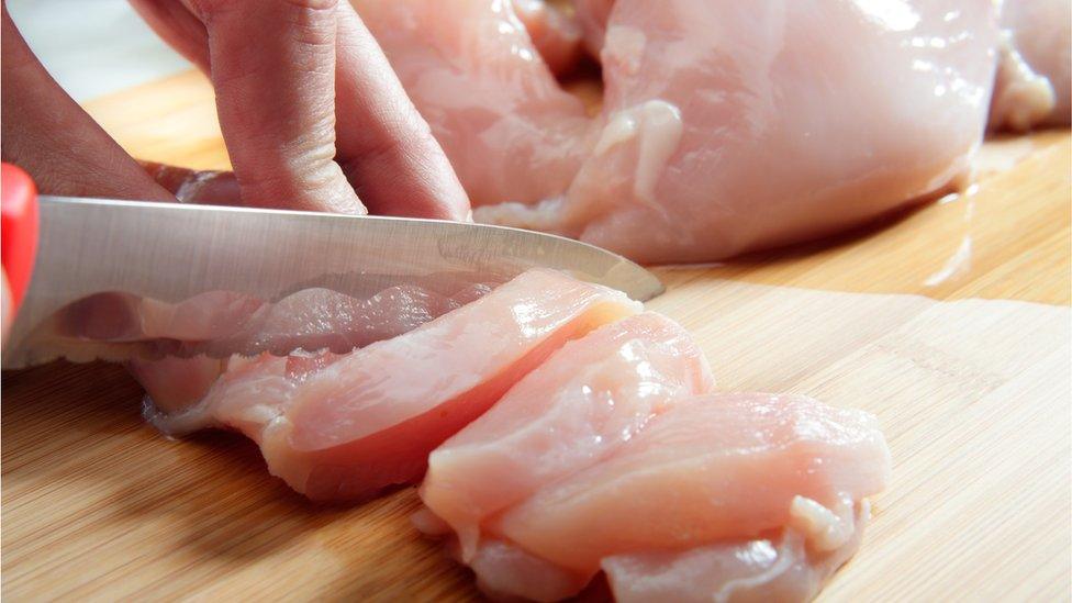 Cutting up chicken with a knife