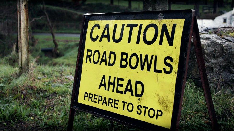 Road bowling sign