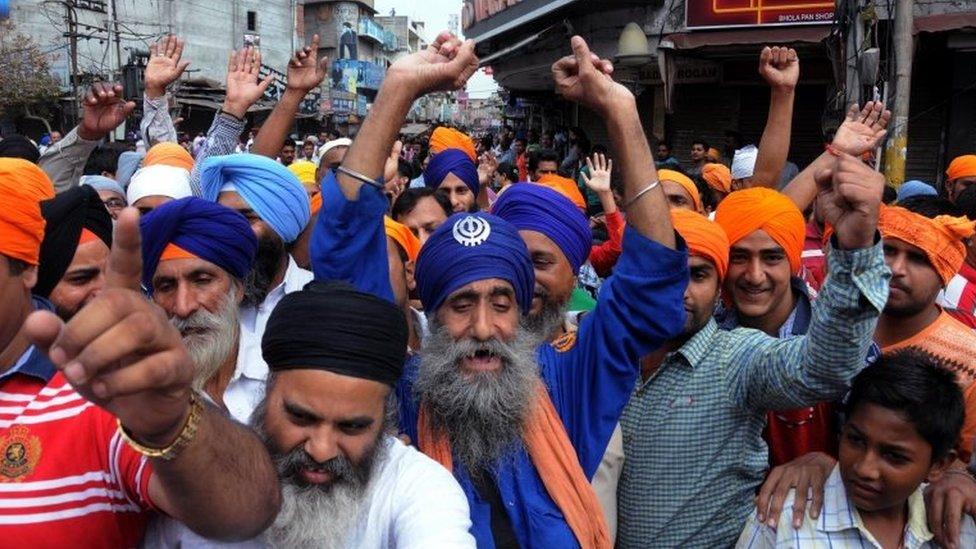 Sikh activists shout slogans during a protest over the alleged desecration of the Sikh holy book at a village near Tarn Taran, in Amritsar, India, 19 October 2015