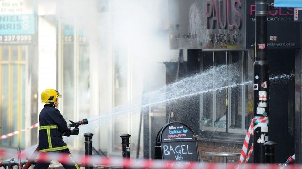 Firefighters at the scene of a fire at Paul's Hair World