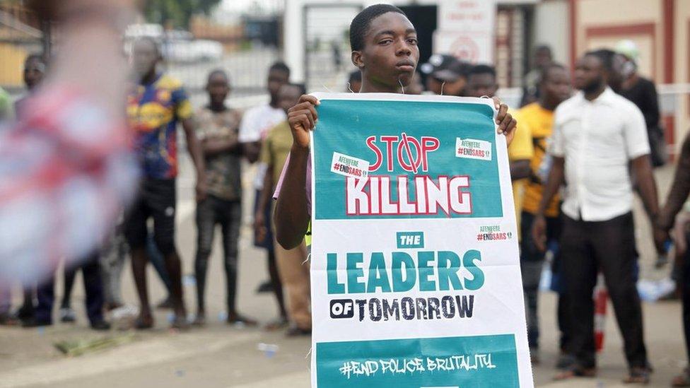 A boy holds a banner during a protest