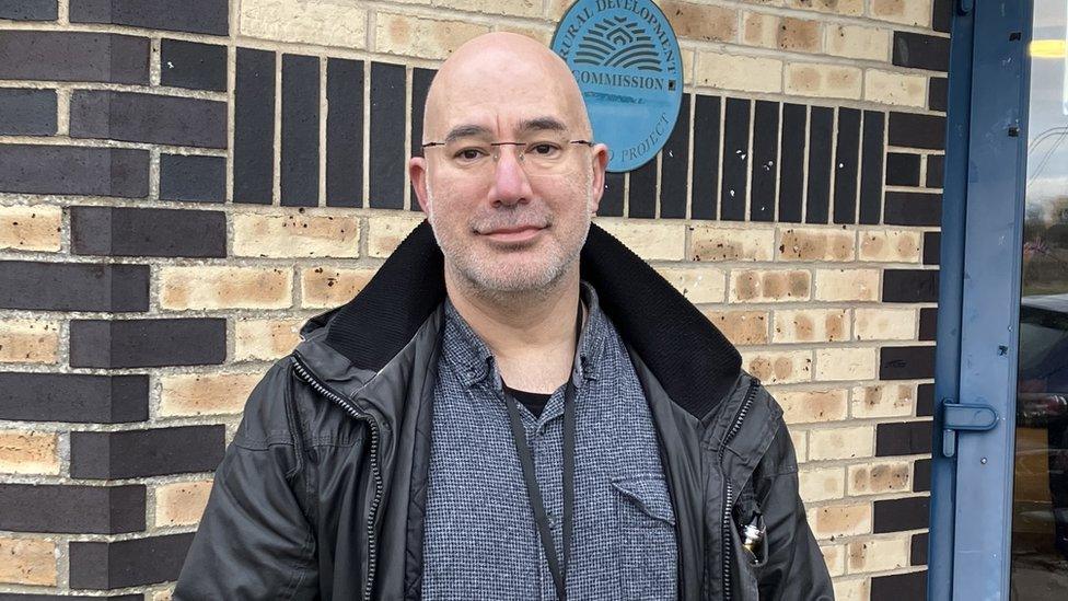 Man in front of a wall