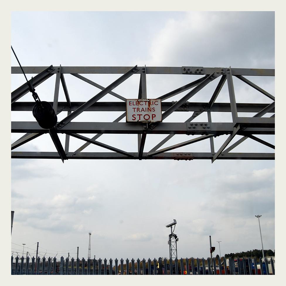 A sign warning of the dangers of the electric trains, near Glasgow, Scotland