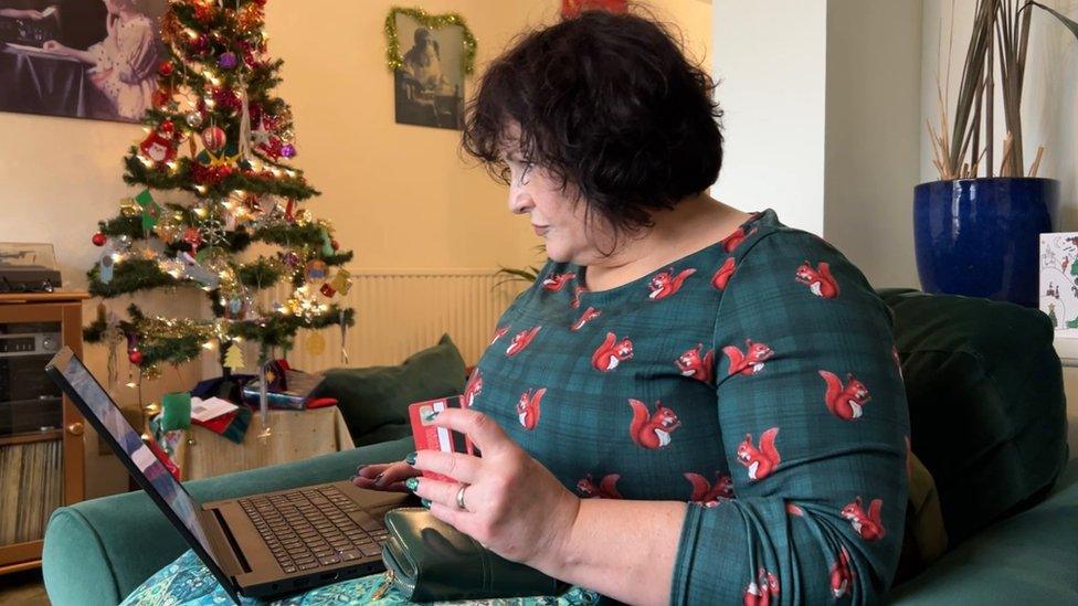 Sarah Douglas using a bank card while shopping online