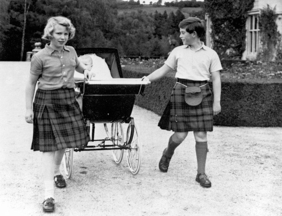 Princess Anne and Prince Charles with Prince Andrew in a pram