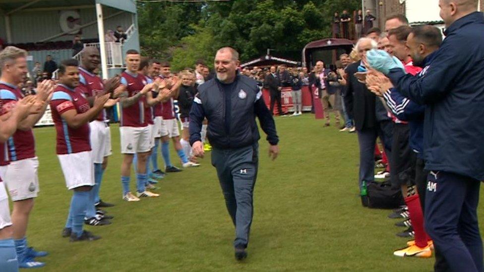 John Cooke is given a guard of honour as he walks on to the pitch ahead of the testimonial