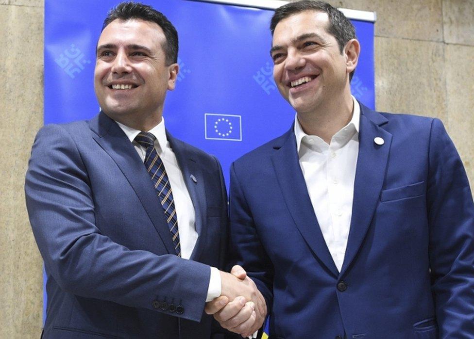 Alexis Tsipras and Zoran Zaev pictured smiling and shaking hands on the sidelines of an informal EU summit