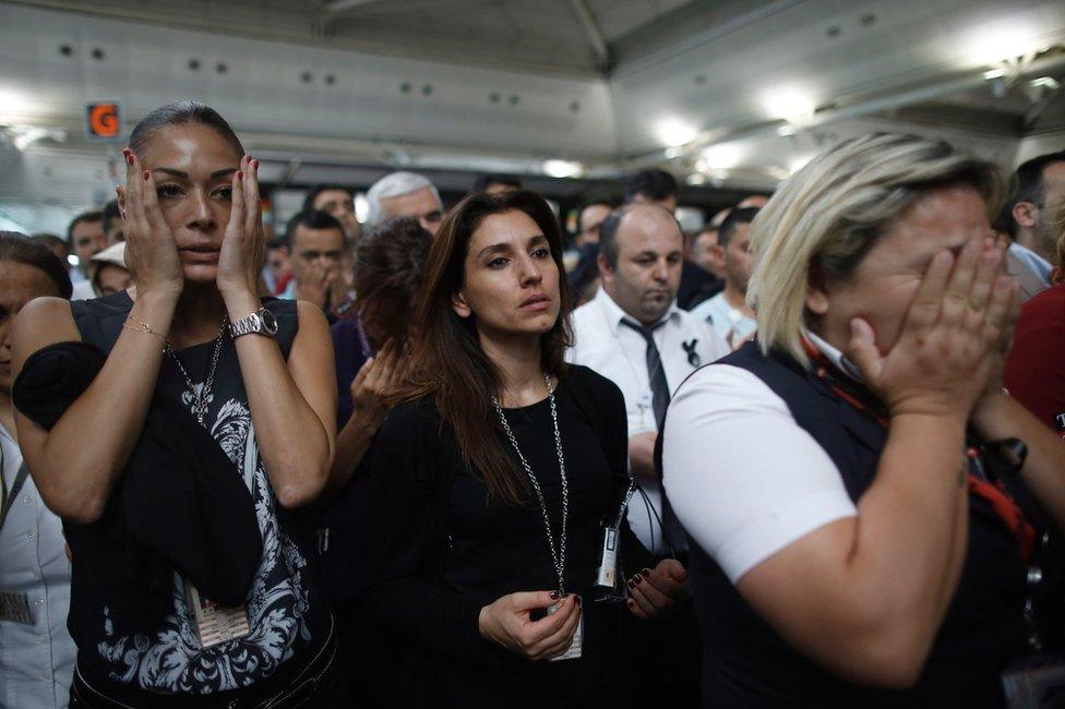 People weep at the memorial ceremony at Ataturk airport, 30 June