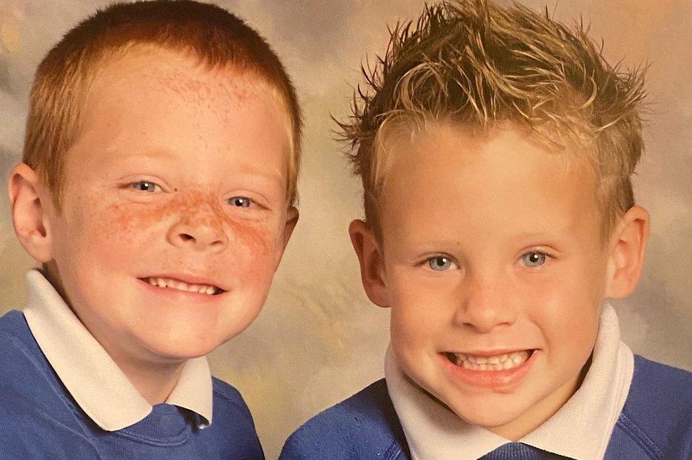 Two young boys smile at the camera