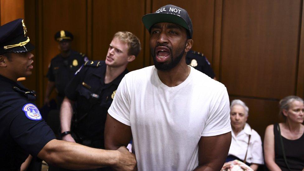 A man protests as US Supreme Court nominee Brett Kavanaugh arrives on the first day of his confirmation hearing