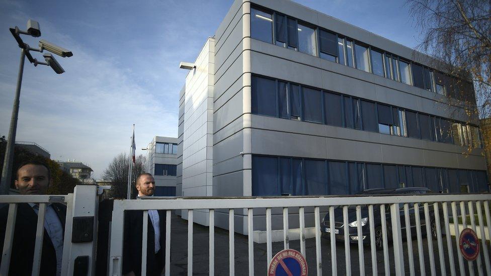 People stand outside the headquarters of the French far-right Front National (FN) party in Nanterre on December 14, 2015