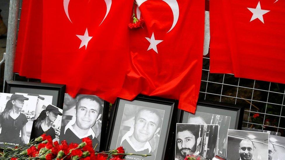 Flowers and pictures of the victims are placed near the entrance of Reina nightclub