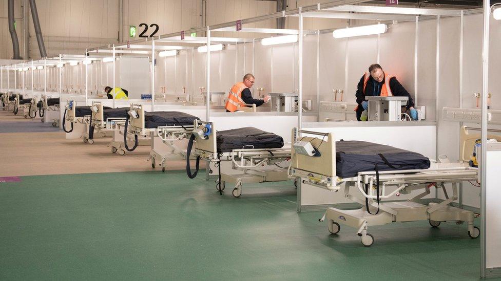 Contractors work at ExCel London while it was converted into the temporary NHS Nightingale Hospital