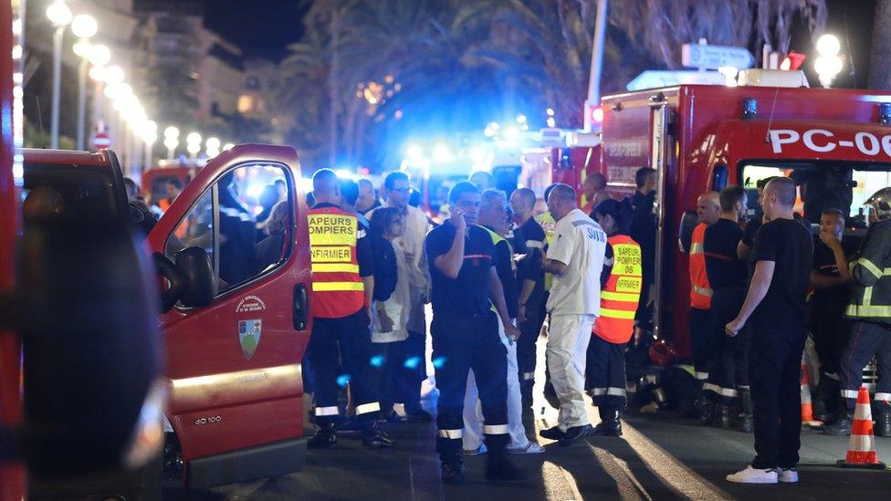 Emergency service workers and their vehicles near the attack site on the Promenade des Anglais