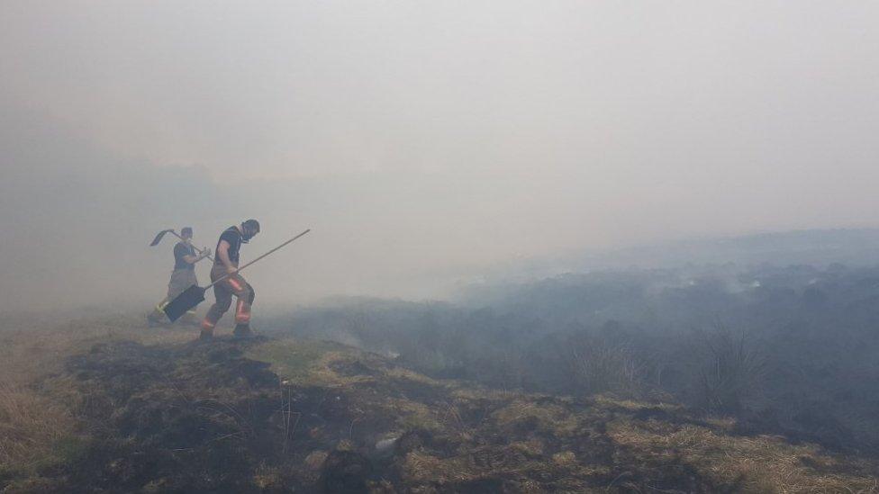 Firefighters tackling a blaze at Lyme Park