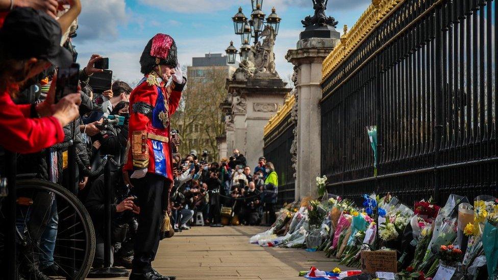 Mourners lay flowers outside Buckingham Palace following the announcement of the death of The Prince Phillip, Duke of Edinburgh